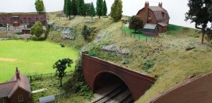 Tunnel entrance with house and cricket pitch
