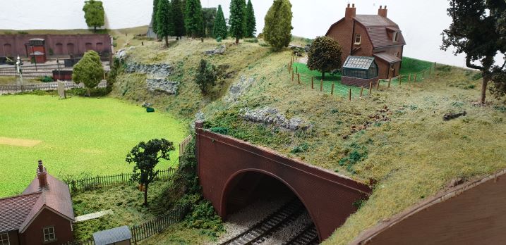 Tunnel entrance with house and cricket pitch